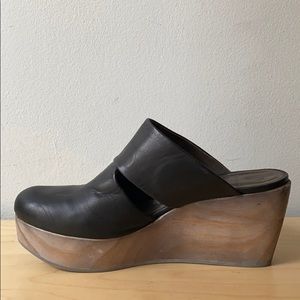 Coclico black leather clogs.